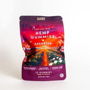 A colorful pouch labeled "Habit - High Spectrum Assorted" contains 10 gummies, featuring floral graphics and product info on the front.