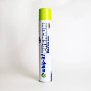A 420ml Whip-It! Butane canister with a green cap, white body, and blue text stands upright against a plain background.